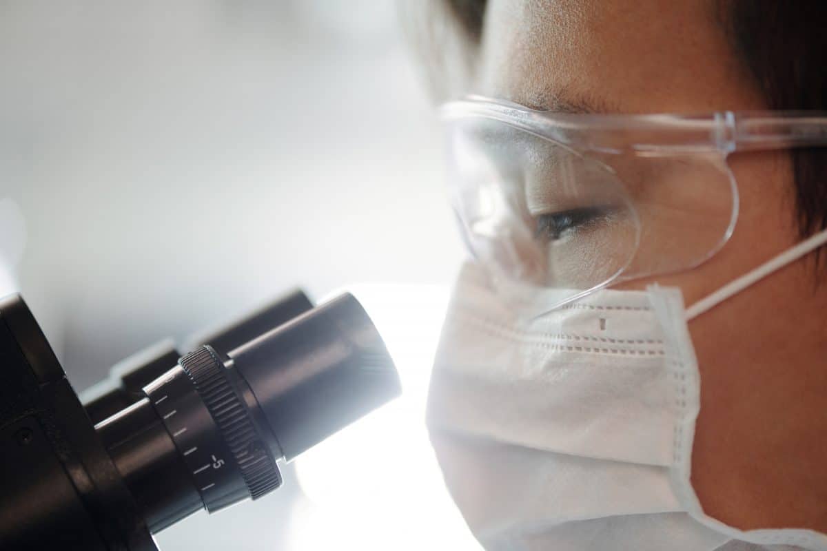 A researcher using a microscope.