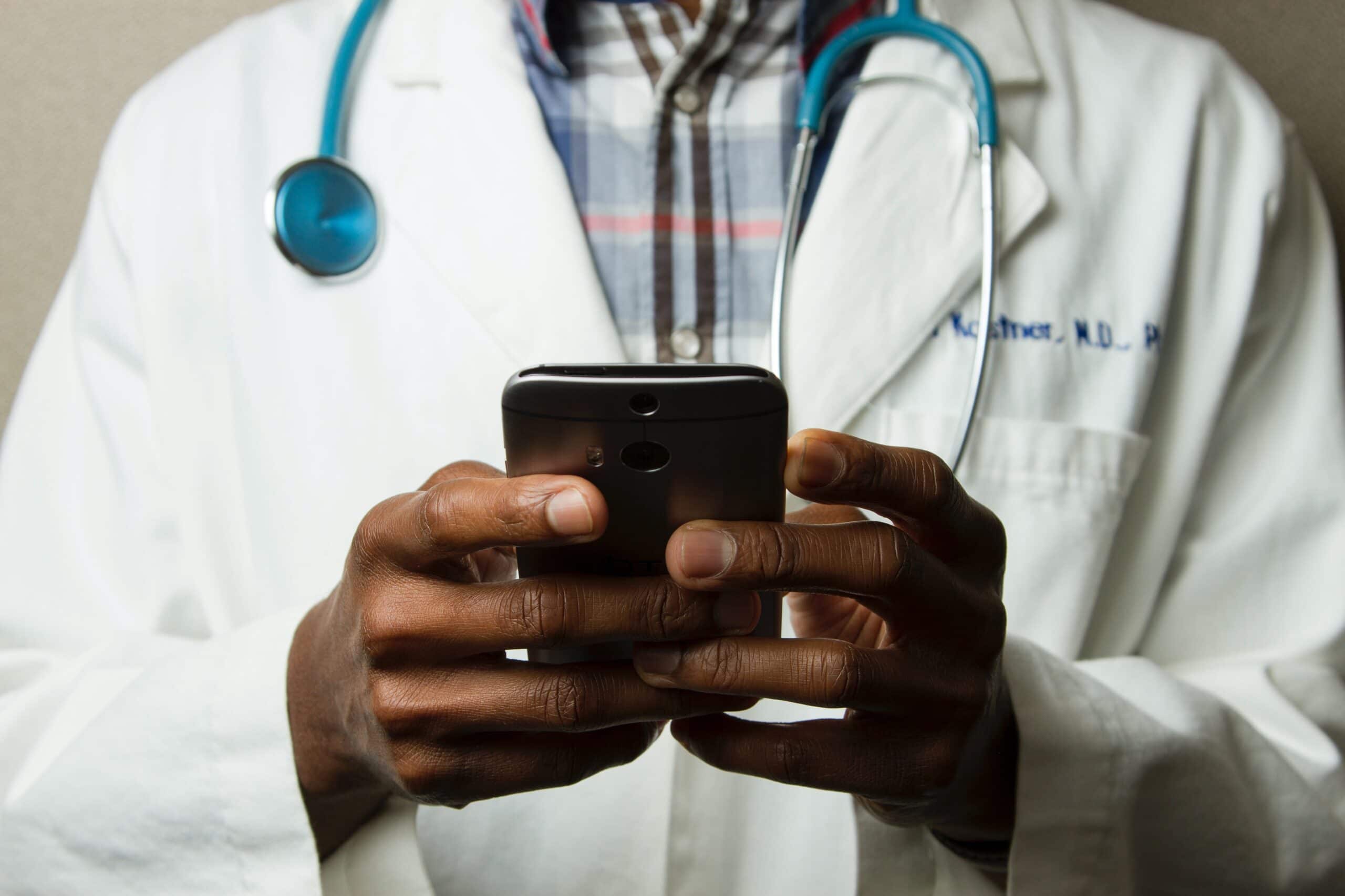 Doctor using his cell phone to communicate with patient after-hours