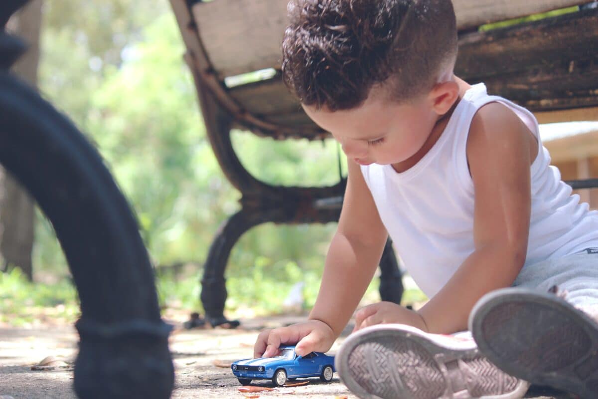 boy playing with toy car