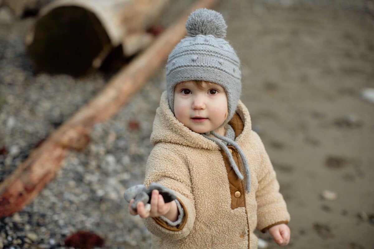toddler outside in coat and hat