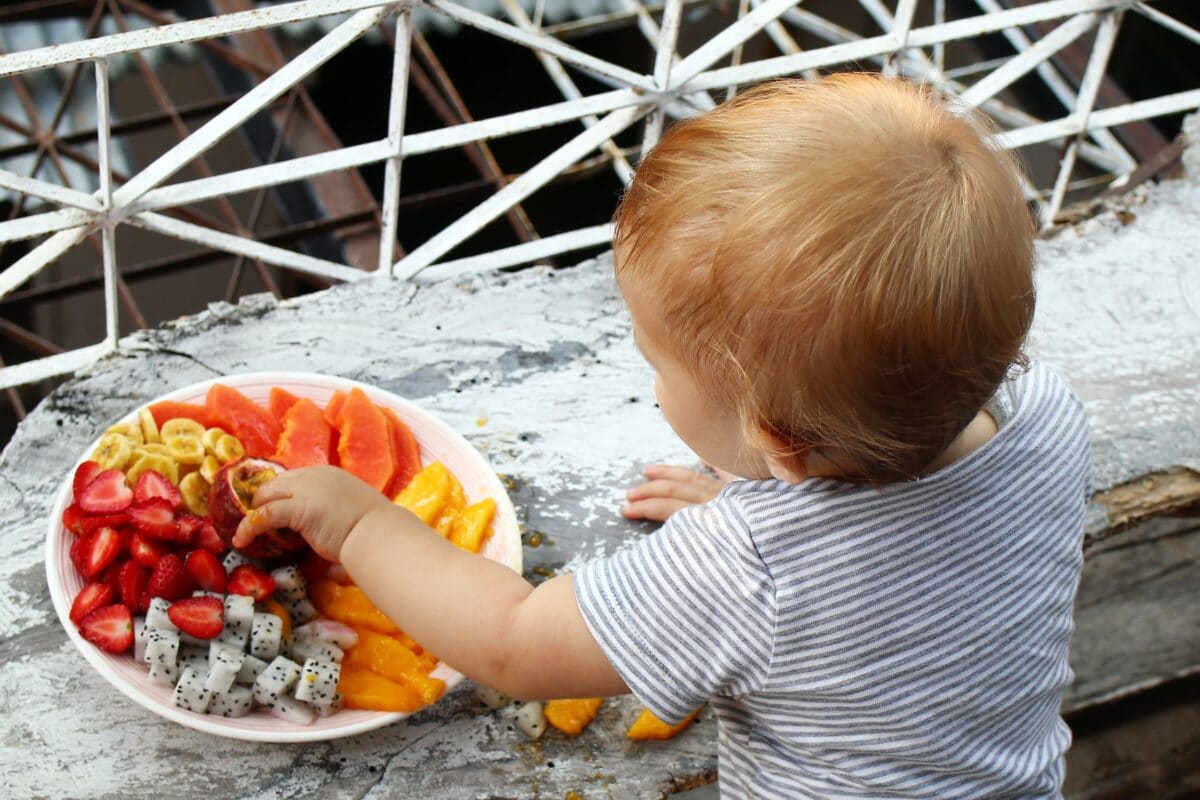 baby-eating-from-plate-of-fruit-1200x800.jpg