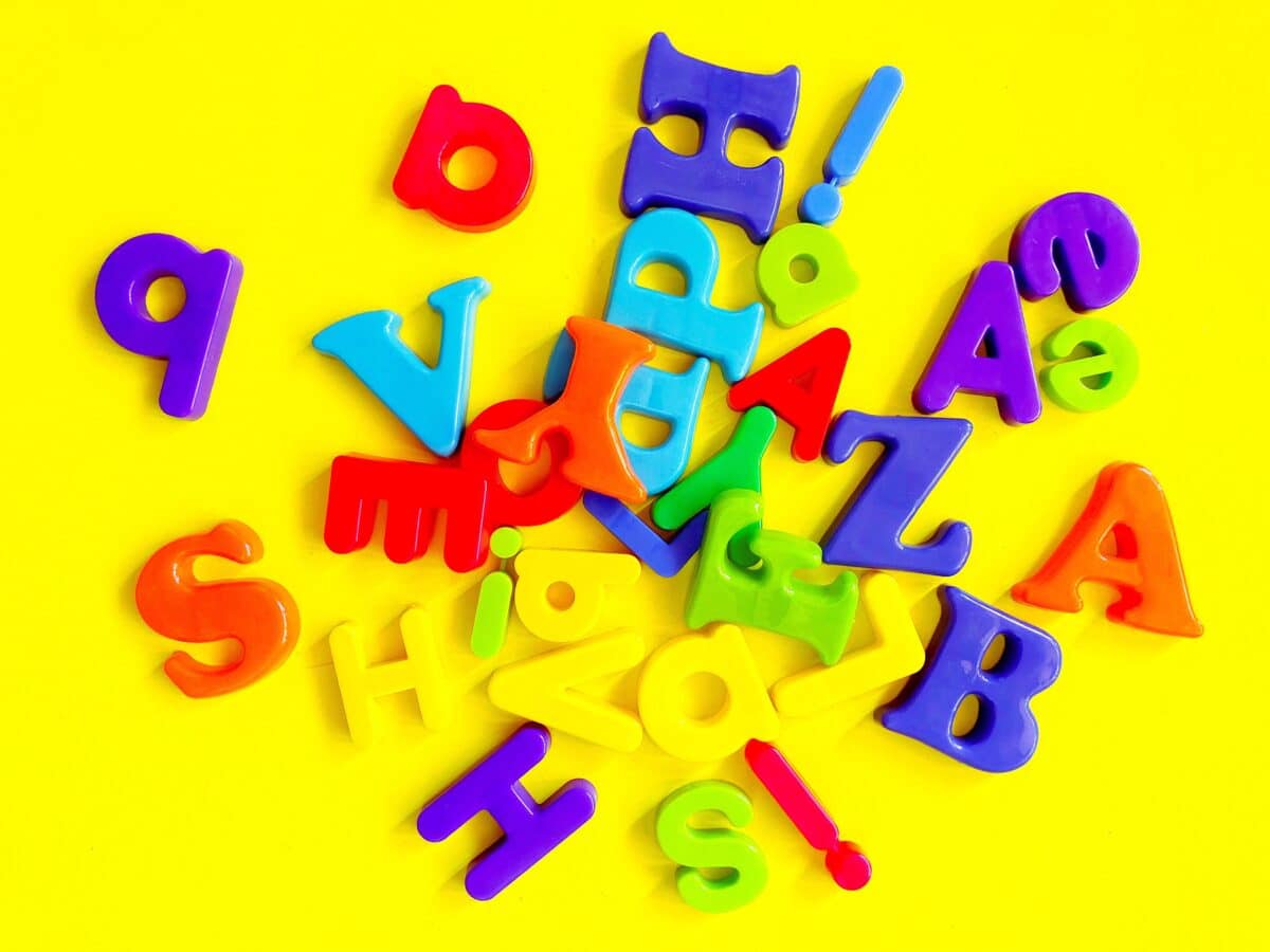 pile of alphabet magnetics on yellow background