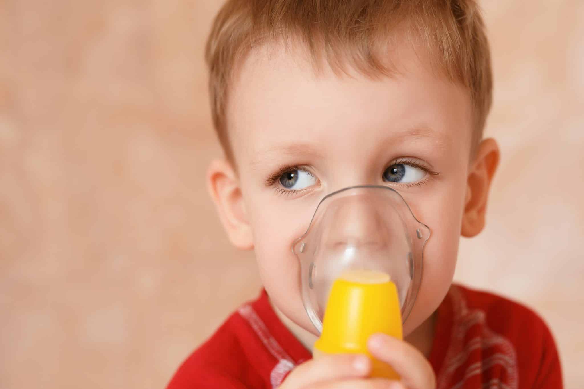 Young boy using a breathing treatment due to his care of croup
